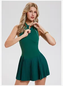 Detailed view of a dark green athletic tennis dress with a half-zip collar and pleated skirt