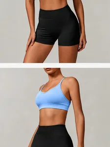 Detail view of seamless light blue sports bra and high-waisted black yoga shorts.