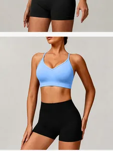 Detailed view of a seamless light blue yoga sports bra and black fitness shorts