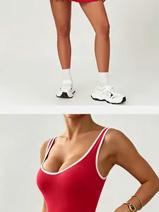 Close-up detail of a red quick-dry tennis dress with white trim and u-neckline.