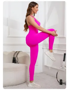 Side view of women's neon pink seamless yoga jumpsuit with criss-cross back straps