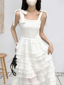 Elegant white sleeveless tiered ruffled dress with bow-tie straps and A-line mesh skirt.