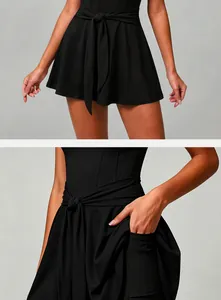 Detail of black tennis dress showing the tie-waist design and a convenient side pocket.