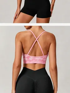 Back view of pink tie-dye sports bra with cross straps and black seamless leggings.