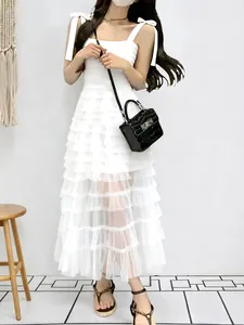 Elegant sleeveless white mesh tiered maxi dress with bow shoulder straps for women