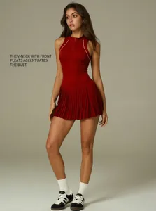 Professional detailed shot of the red tennis dress with half-zip and pleated skirt