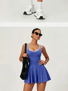 Detail view showing white athletic sneakers and a blue pleated sports tennis dress