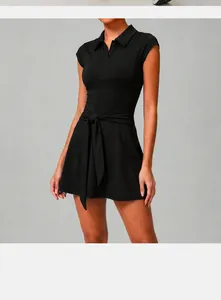 Detail view of women's black athletic tennis dress with polo collar and waist tie