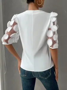 Detailed back view of white V-neck blouse featuring 3D hollow dot mesh puff sleeves.