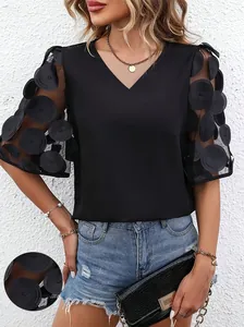 Close-up of elegant V-neck blouse featuring 3D polka dot sheer mesh puff sleeves