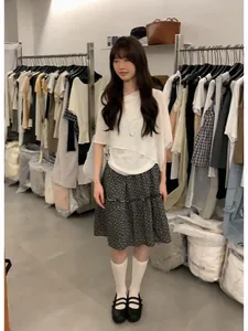 Detailed view of a sweet Korean style floral midi skirt and white asymmetric top