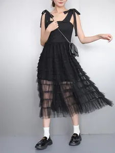 Full body view of an elegant black sleeveless tiered mesh dress on an Asian model