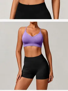 Detail view of seamless knitted purple sports bra and black yoga shorts on model