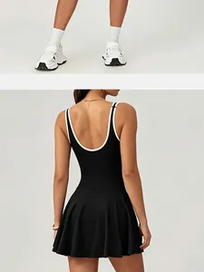 Detailed back view of a black pleated athletic tennis dress with white contrast piping.