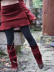 Detail of red layered irregular skirt with gray leggings and matching leg warmers.