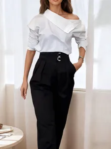 Elegant off-shoulder white blouse paired with black high-waisted trousers for a chic look