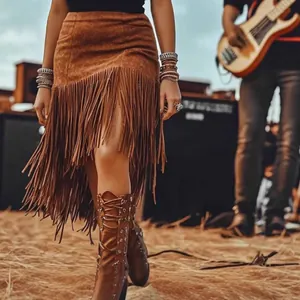 Close-up of a brown suede high waist skirt with long fringe details in a boho setting