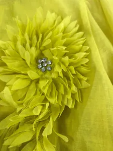 Close-up detail of 3D chiffon flower applique with sparkling rhinestone center