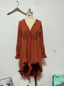 Detailed view of a bohemian rust orange long sleeve ruffle high-low party dress on a mannequin