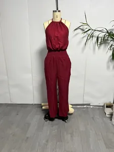 Front view of a wine red linen halter jumpsuit showcased on a professional mannequin