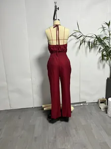 Rear view of a burgundy sleeveless linen jumpsuit with a backless design and tied neck.