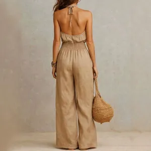 Back view of an elegant khaki linen backless jumpsuit with smocked waist detail