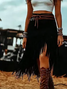 Bohemian style black faux suede fringe skirt with high waist and brown tie belt detail.