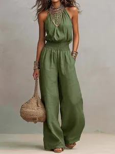 Full length detail of olive green linen halter-neck jumpsuit with a smocked waist
