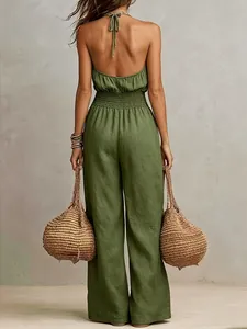 Back view detail of a women's green linen halter neck jumpsuit with smocked waist