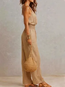 Elegant sleeveless linen backless jumpsuit featuring wide legs and a smocked waist design