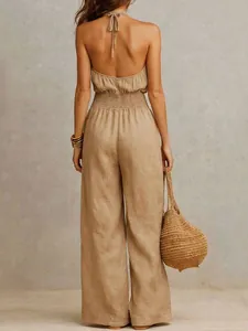 Fashionable tan linen sleeveless backless halter jumpsuit for women shown from the back