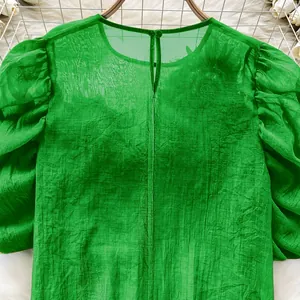 Elegant green sheer chiffon blouse with lantern sleeves and floral applique detail.
