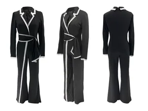 Elegante mono de manga larga en blanco y negro con diseño de cinturón para mujer