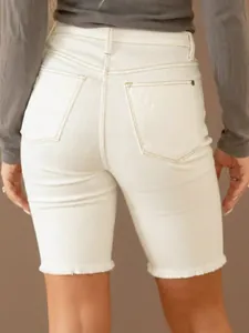 Back view of women's white denim Bermuda shorts with stylish frayed hem detailing
