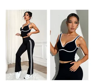 Detailed view of black and white yoga set with contrast piping and flared leggings