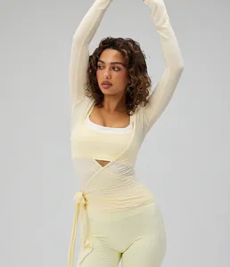 Professional detail of cream long-sleeved ballet style yoga wrap top for fitness