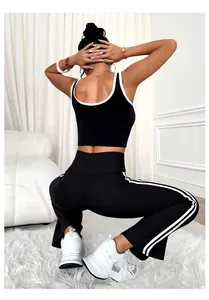 Rear view of black and white contrast trim yoga set featuring flared leggings and a tank top