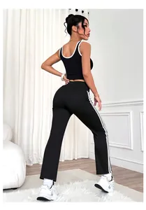 Rear view of black and white contrast yoga flared pants featuring athletic side stripes