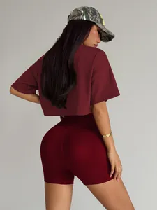 Back view of a maroon seamless yoga set featuring crop top and high-waisted shorts.