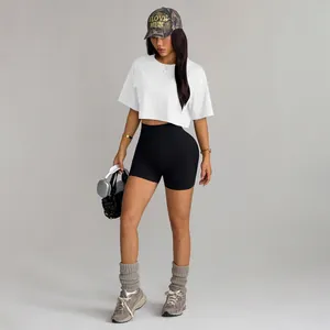 Athletic set featuring high-waisted black seamless biker shorts and white cropped t-shirt
