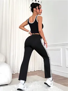 Black and white yoga set featuring sports bra and flared pants with side stripes