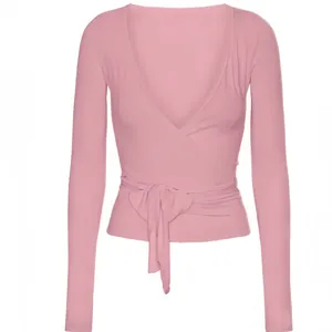 Elegant pink ballet-inspired wrap yoga top with long sleeves and a stylish waist tie