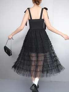 Back view detail of elegant black sleeveless A-line midi dress with tiered tulle mesh skirt