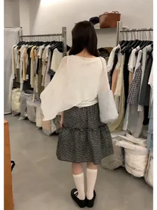Stylish Korean floral skirt and white asymmetric top ensemble shown from the back