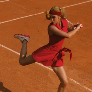 Vibrant red sleeveless athletic tennis dress with waist tie for outdoor sports