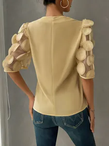 Elegant yellow blouse featuring mesh puff sleeves with unique 3D circle appliques back view.