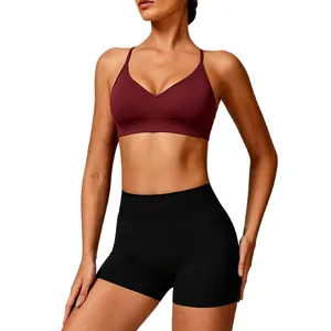 Seamless knitted yoga sports bra with cross back straps and black fitness shorts set