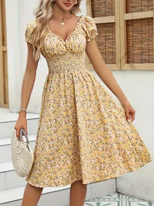Close-up view of a French vintage floral midi dress featuring puff sleeves and V-neck.