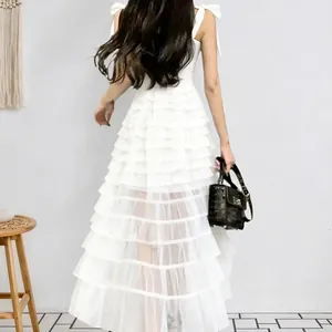 Elegant white tiered mesh sleeveless maxi dress with a flowing A-line silhouette.