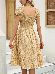 Elegant back view of a yellow French vintage floral midi dress with a smocked waist detail